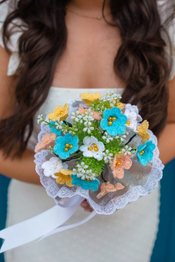 A handmade crochet flower bouquet held in both hands