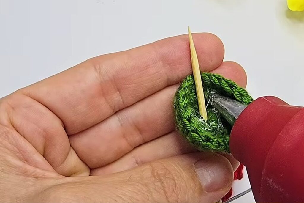 Hot glue added inside the green cup around the skewer