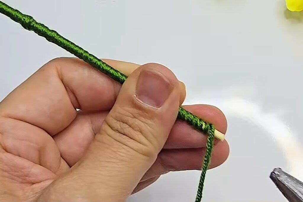Wrapped green stem with the yarn end glued at the bottom