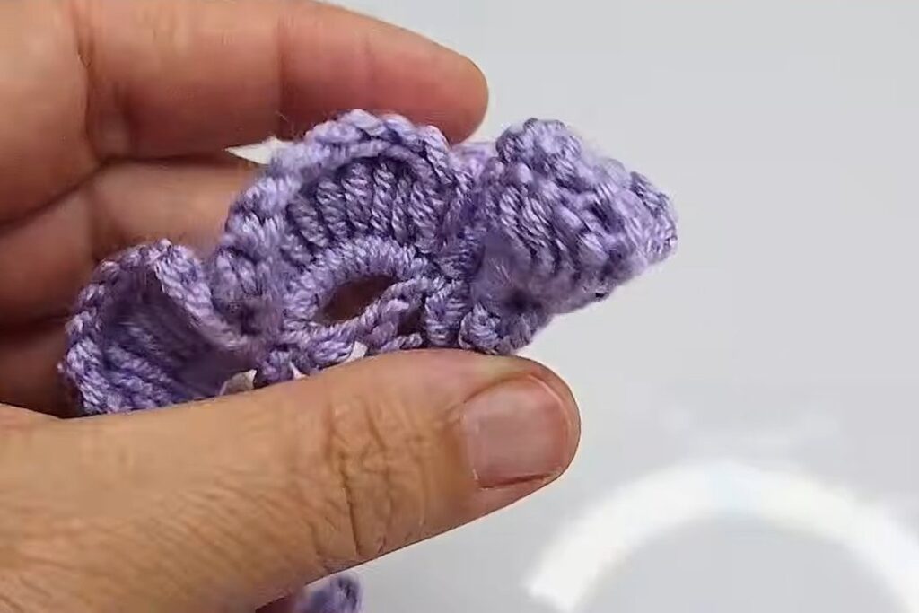 Finished strip of fan petals ready to roll into a crochet rose