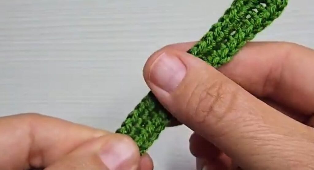 Finished long narrow green wired leaf for a crochet rose with stem