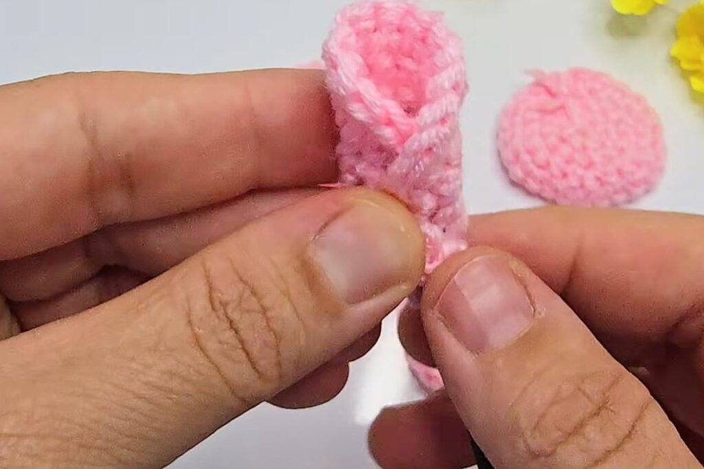 First pink crochet circle rolled round the stem into the rosebud centre