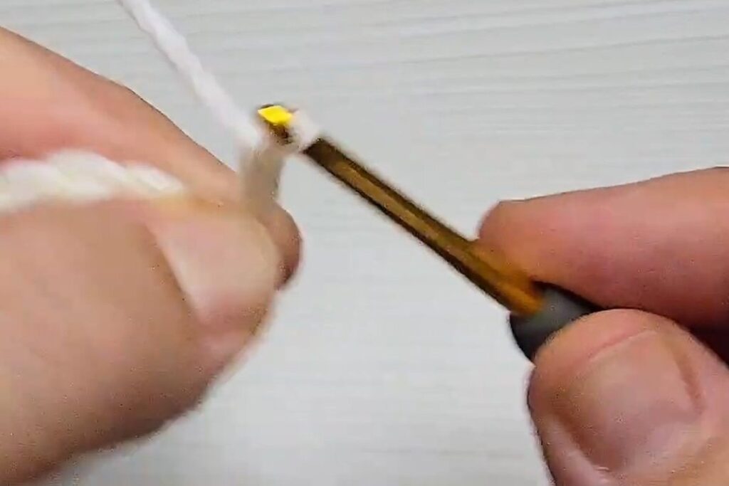 Chaining 5 to make the first petal loop of a layered crochet flower