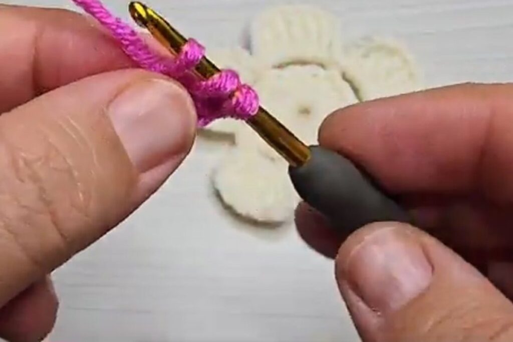 Two double crochet in the fourth chain from the hook for a layered crochet flower rose