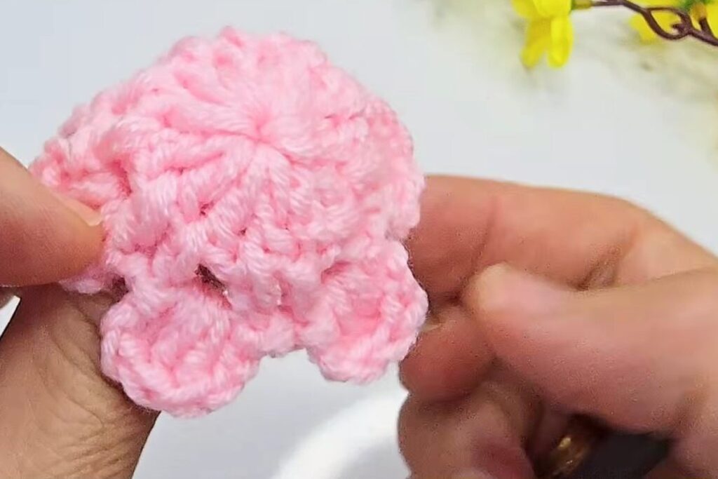 Finished two-tier pink crochet blossom seen from above