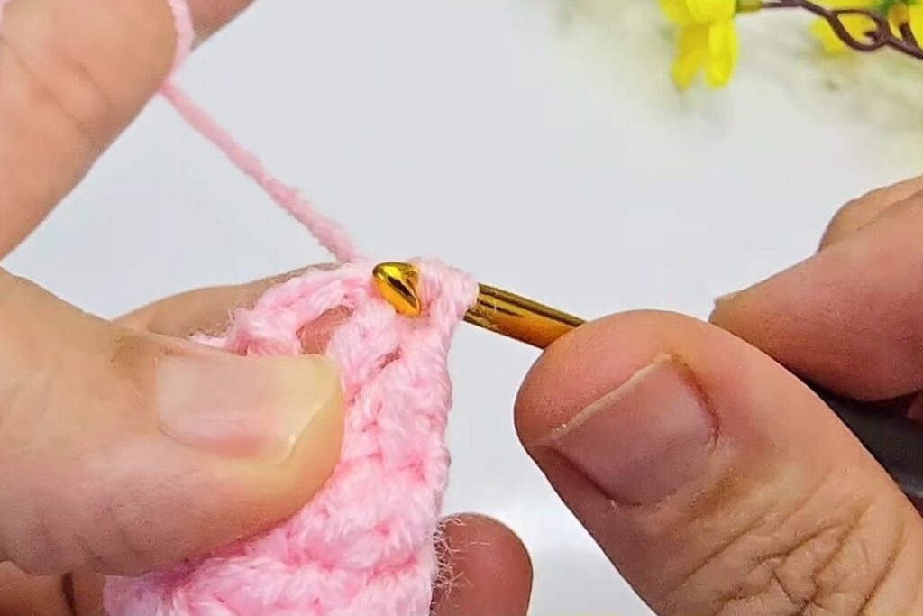 Finished pink crochet cup for the base of a mini crochet flower bouquet blossom