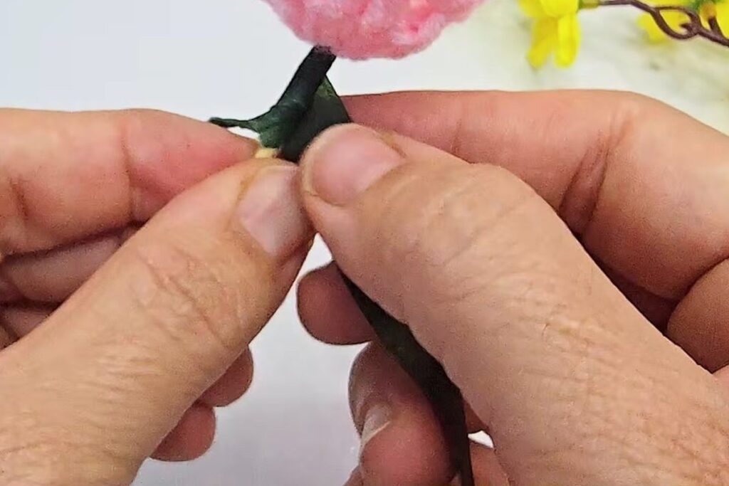 Green stem tape wrapped around the base of the blossom