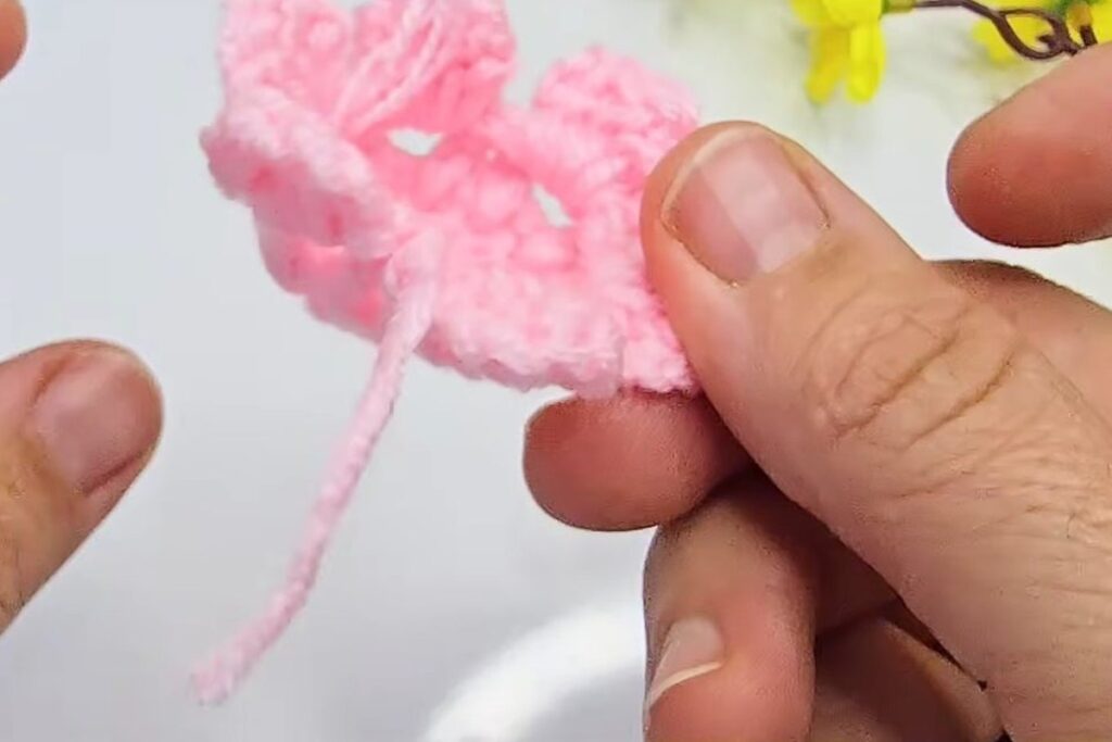 Second tier of petals being added around the outside of the pink cup