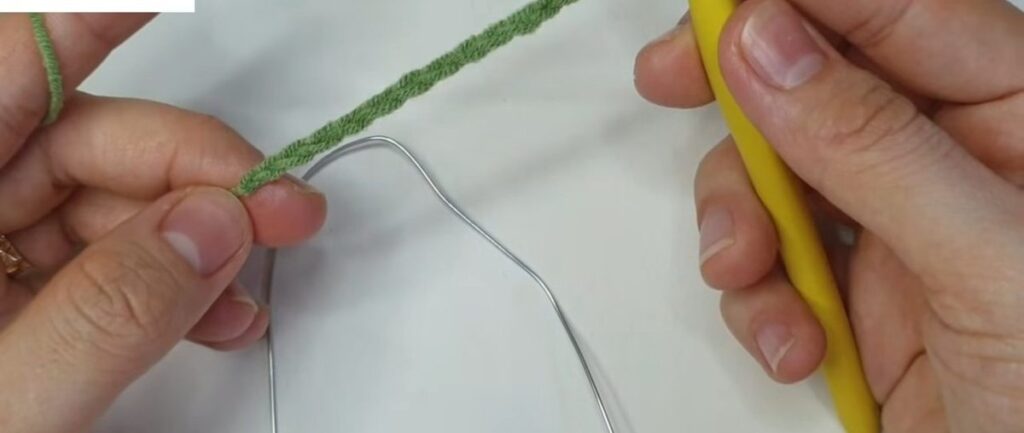 Green chain of 15 with a piece of wire laid alongside for a crochet lavender flower leaf
