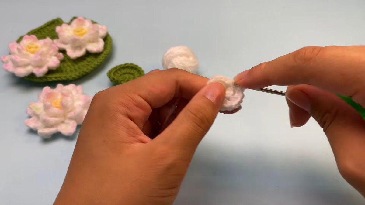 Small flat disc with increases worked in the back loops for round 2 of a crochet lotus flower