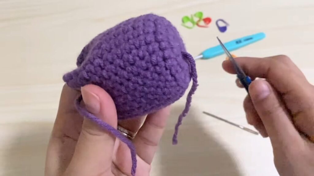 hiding the final yarn ends on a finished free crochet tulip pattern tulip head