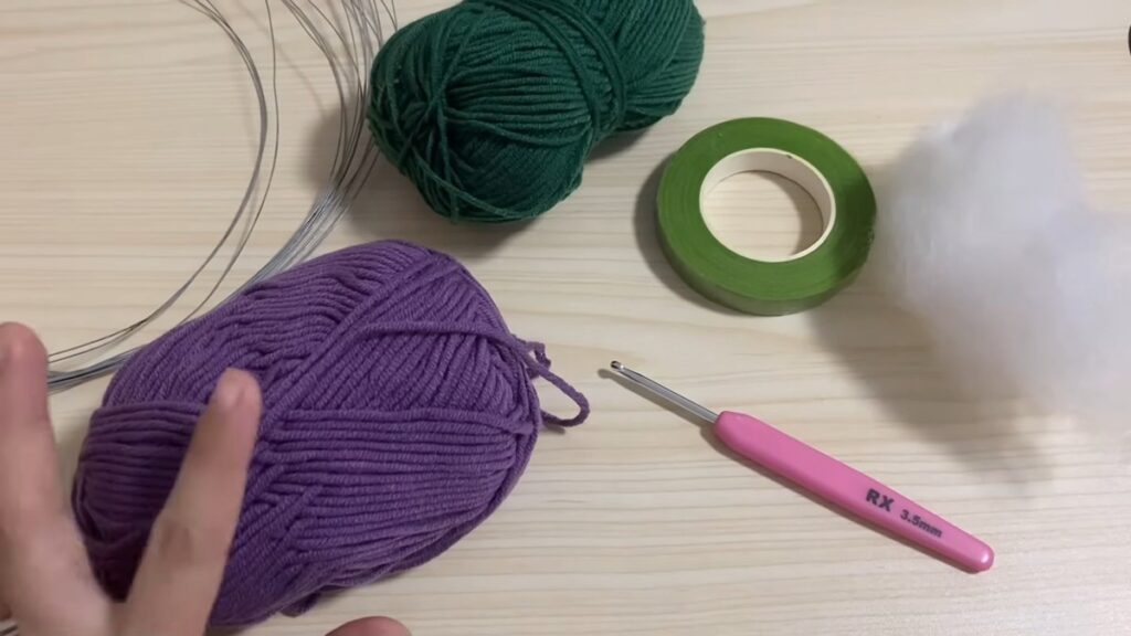 yarn, hook and filling set out for a free crochet tulip pattern